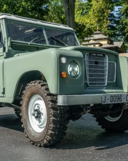 A Classic Land Rover Series III 109 in Light Green with White Wheels. This car has been restored and customized.